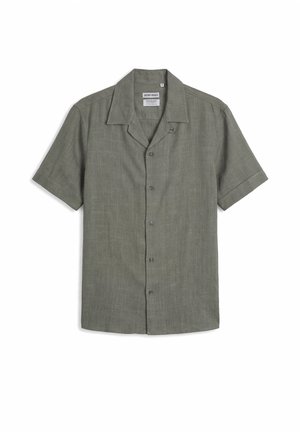 Chemise olive à manches courtes, avec boutons, col camp, texture en toile unie et étiquettes de marque visibles à l’intérieur de l’encolure.