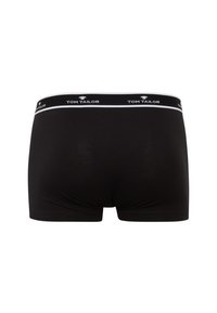 Boxer neri realizzati in tessuto morbido con una cintura elastica bianca che presenta il logo "TOM TAILOR". Design semplice e aderente con dettagli minimi.