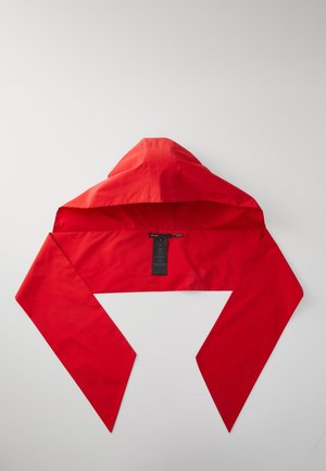 Red hooded scarf with long pointed ends laid flat on a white surface, showing a black clothing label inside the hood.