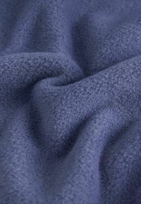 Navy blue fleece fabric with a soft, textured surface, featuring gentle waves and subtle variations in thickness and light reflection.