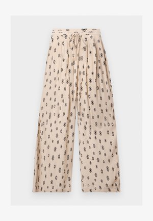 Μπεζ παντελόνια με φαρδύ πόδι και μαύρο γεωμετρικό σχέδιο, ελαστική μέση και κορδόνι μπροστά με διακοσμητικά άκρα σε χρυσό χρώμα.