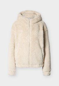 Φωτογραφία μιας μπεζ, χνουδωτής, με κουκούλα, ζακέτας με φερμουάρ μπροστά και μακριά μανίκια, σε απλό γκρι ανοιχτό φόντο.