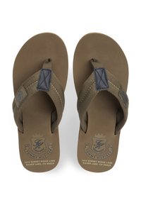 Καστανόπρασινα σαγιονάρες με υφασμάτινα λουριά, υφή σόλας και λογότυπο τυπωμένο στην εσωτερική σόλα. Περιλαμβάνει έντονες ραφές.