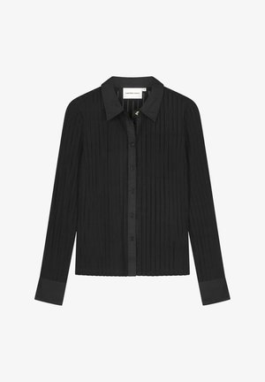 Zwart shirt met lange mouwen en een geribbelde textuur, knoopsluiting, klassieke kraag en contrasterende manchetten. Ontworpen met een aansluitend silhouet.