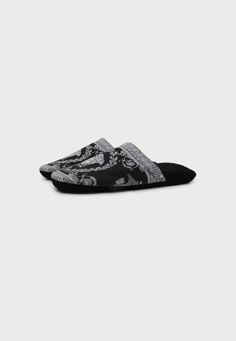 Pair of black slip-on slippers with gray intricate floral and paisley patterns on the upper fabric and soft black soles.