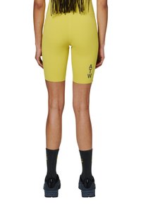 Geel fietsshorts van rekbaar materiaal met een hoge taille, voorzien van een effen kleur en een zwart "ATW" logo aan de zijkant.