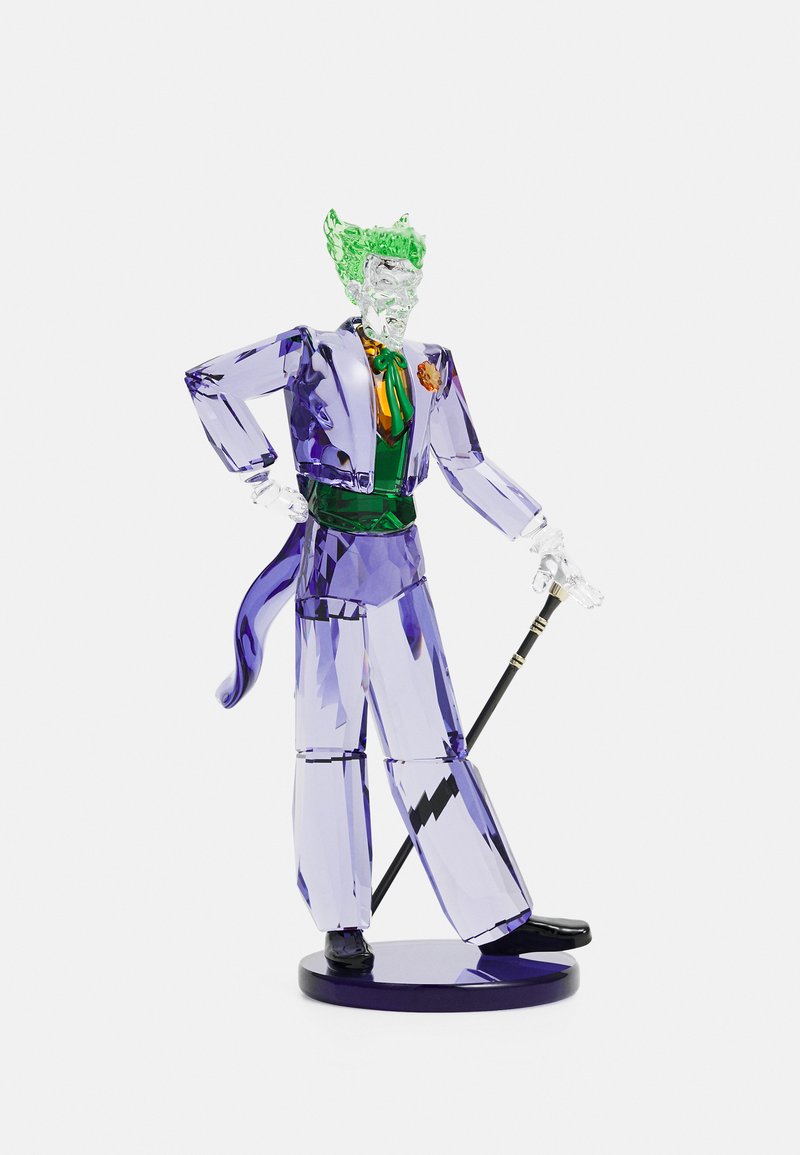 Purple and green crystal figurine of a character, featuring sharp shapes, clear accents, and a black base, holding a cane with a gold detail.