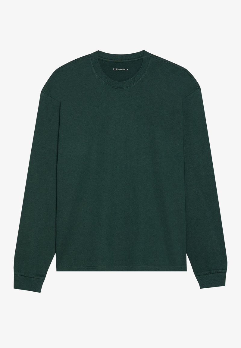 Chemise à manches longues en coton vert foncé. Dotée d'un col rond, d'une coupe décontractée et de poignets côtelés. Texture lisse, design minimaliste sans motifs.