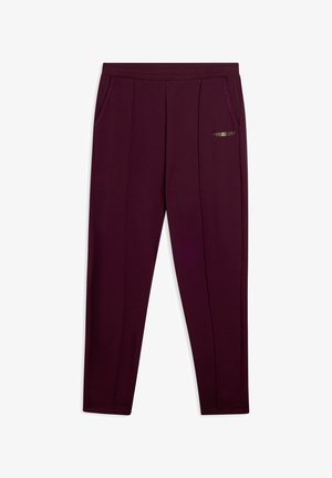 Pantalons de sport maroon en tissu doux, dotés de deux poches latérales et d'un discret logo "FREDDY" à l'avant. Design à jambe fuselée.