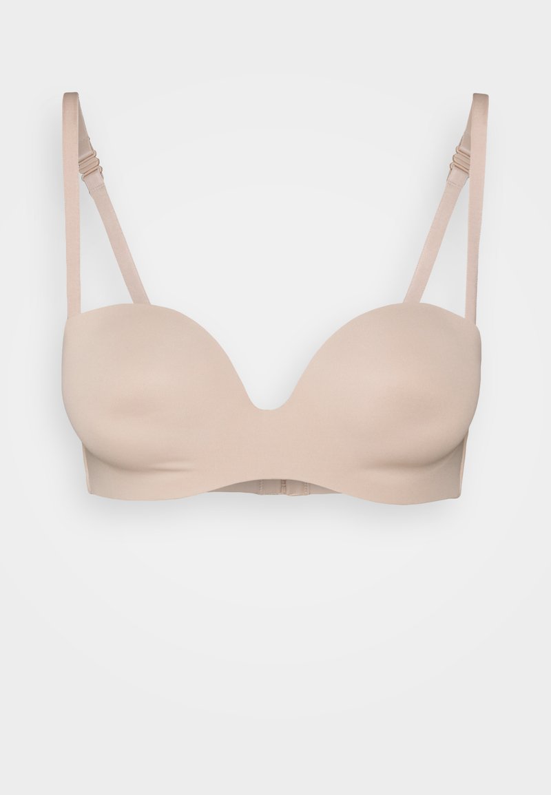 Beige gevormde push-up beha van gladde stof, met verstelbare banden en een haak-en-oogsluiting op de achterkant. Naadloos ontwerp voor comfort.