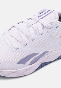Light purple athletic shoe with mesh upper, textured overlays, reinforced toe, and a flexible sole featuring diamond tread pattern.