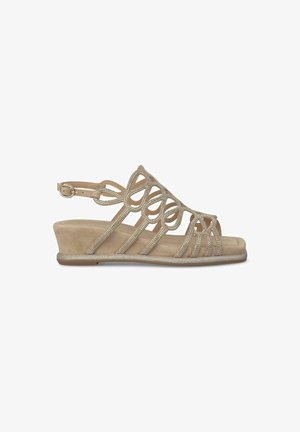 Beige wedge sandal with decorative straps and rhinestone accents, featuring soft suede material and an adjustable ankle strap.