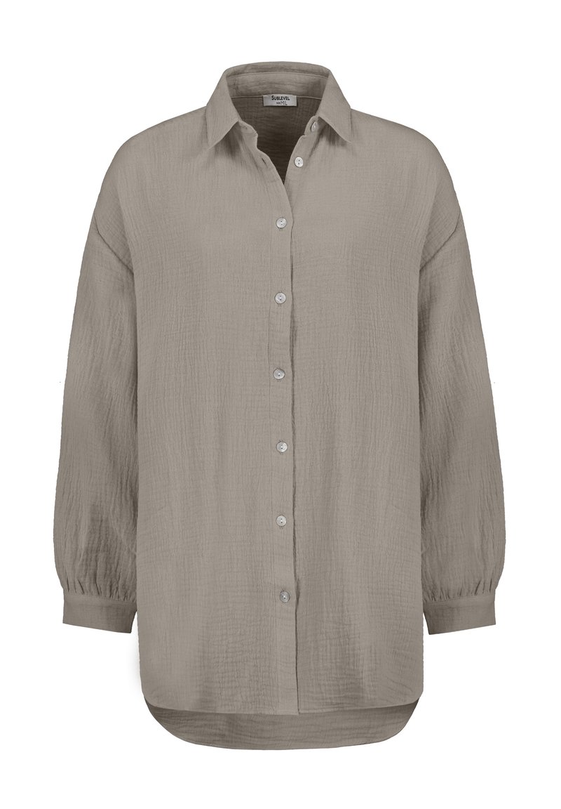 Long-sleeve button-up shirt in light gray, made of textured fabric. Features a classic collar, rounded hem, and button closure.