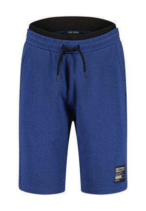Pantaloncini blu fino al ginocchio con cintura elasticizzata, coulisse nera, tasche laterali e una piccola toppa "Decoded Reality" sulla gamba sinistra.