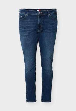 Mørkeblå jeans med rett passform, for-åpning med knapp og glidelås, lommer foran og bak, og beltehemper.