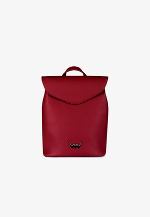 Red faux leather backpack with a fold-over flap and a top handle. Features a black logo accent at the bottom. Smooth texture throughout.