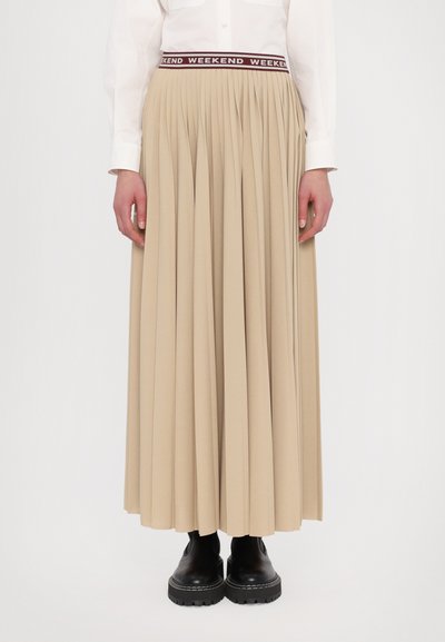 Plisseret beige nederdel med kontrasterende bordeaux "WEEKEND" talje, parret med sorte solide støvler. Glat stof, ankellang design.