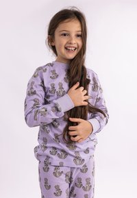 Lilac pajamas featuring a repetitive playful rabbit print. Long-sleeved top with ribbed cuffs, matching elastic waistband pants. Soft cotton material.