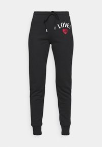 Black sweatpants with a drawstring waist, featuring white "LOVE!" text and a sparkly red heart design on the left hip.