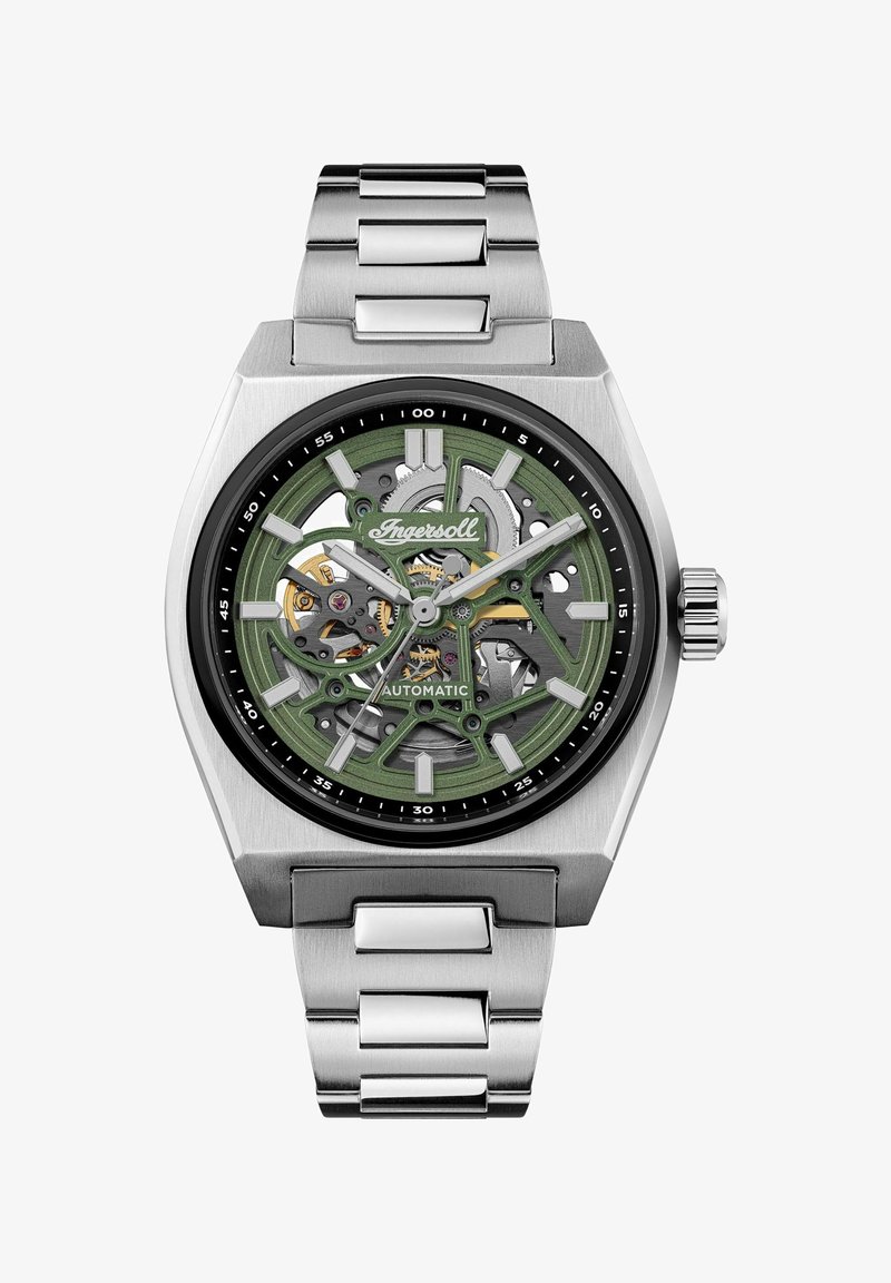 Automatisk ur i rustfrit stål med en grøn mønstret skive, synlige gear, sort bezel og sølvfarvede led i et strømlinet, kantet design.