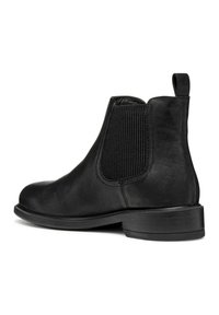 Botas de cuero negras hasta el tobillo con paneles laterales elásticos, punta redondeada y una lengüeta en la parte posterior. Suela de goma plana con un dibujo mínimo.