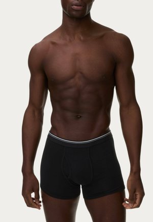 Schwarze Baumwoll-Boxershorts mit enganliegendem Sitz, versehen mit einem kontrastierenden weißen Bund und einer glatten, strukturierten Oberfläche.