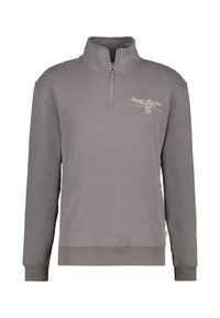 Sweatshirt gris zippé avec un col haut, présentant un logo en broderie blanche sur la poitrine, et des poignets et un ourlet côtelés. Texture douce.