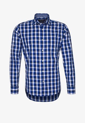 Chemise à manches longues avec boutons, motif à carreaux bleu, noir et blanc, col pointu.