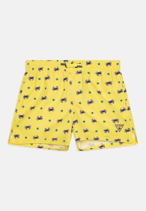 Costume da bagno giallo con un motivo di granchio e stella marina blu. Vita elasticizzata con cordino. Logo applicato sul lato inferiore.