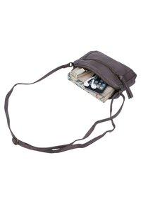 Gray leather crossbody bag with a front zipper pocket, holding a phone, lip product, and earphones. Features a thin adjustable strap.