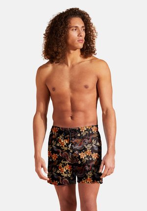 Bedruckte Badeshorts mit schwarzem Grund, die farbenfrohe Drachen- und Blumenmuster zeigen. Leichtes Material, elastischer Bund mit Kordelzug.