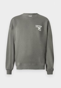 Gray crewneck sweatshirt with ribbed cuffs and hem, featuring small white "Daily Grind NYC" text and cartoon coffee cup graphic on the chest.