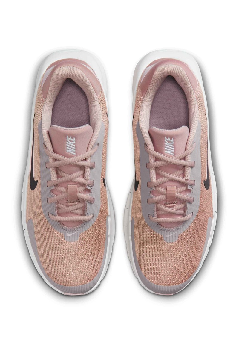 Nike sneakers in light pink mesh with gray accents, featuring rounded toe, lace closure, padded collar, and white rubber sole.