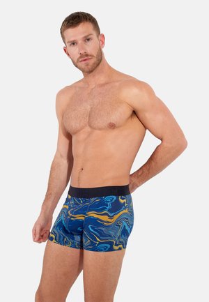 Blaue und gelbe marmorierte Boxershorts mit einem schwarzen elastischen Bund, der mit "HOME" beschriftet ist, und einem enganliegenden Design.