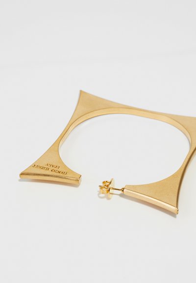 Gold-tone metal earrings in a unique triangular design with a smooth finish. Features a stud backing for secure wear.