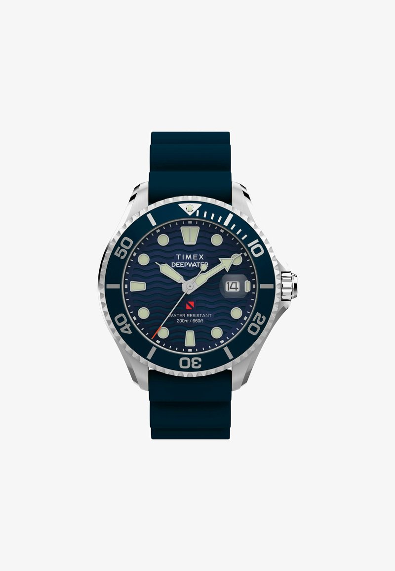 Timex Deepwater watch with a stainless steel case, navy blue rubber strap, wave-patterned dial, luminous markers, and date window. Water resistant to 200m.