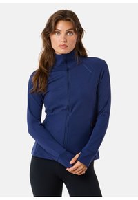 Navy blauwe zip-up jack gemaakt van rekbare stof. Voorzien van een hoge kraag, duimopeningen en zijzakken; gladde textuur met minimale branding.