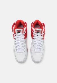 White high-top sneakers with red accents, featuring a lace-up design and perforated toe. Soft inner lining and logo on the tongue.