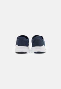 Navy blue sports shoes with a smooth textile upper, white rubber sole, and a minimalist design. Features a padded collar and heel for comfort.