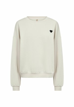 Beige crewneck sweatshirt with long sleeves and small black heart emblem on left chest, ribbed cuffs and hem.