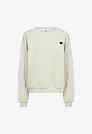 Beige crewneck sweatshirt with long sleeves and small black heart emblem on left chest, ribbed cuffs and hem.