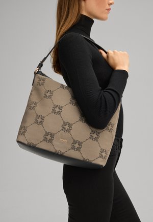 Beige tas met patroon en zwarte accenten en gouden logo. De tas heeft een gestructureerde vorm en een verstelbare schouderband.