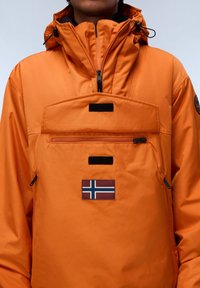 Orange waterproof jacket with a high collar, front zip, chest pocket, and a patch featuring the Norwegian flag. Smooth texture, durable material.