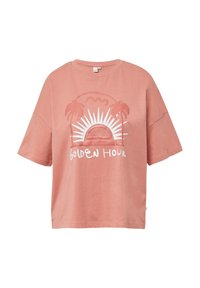 T-shirt en coton rose à coupe ample, avec un graphique blanc représentant un soleil et des palm trees, accompagné du texte "Golden Hour". Manches courtes.