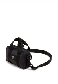 Black nylon bag with two top handles and a detachable shoulder strap. Features a zip closure and a Vans logo patch on the front.