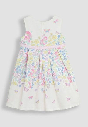 Valge ilma varrukateta kleit, millel on värviline lille- ja liblikamuster, detailsete voldikute ja roosa satiinipaela aktsent vööl. Seljaosa nööpide kinnitamine.