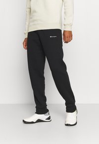 Champion Teplákové kalhoty - black