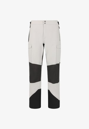 Pantalons de sport gris clair et noir avec un design géométrique en blocs de couleur, deux poches latérales et une fermeture éclair. Fabriqués en un matériau lisse et flexible.
