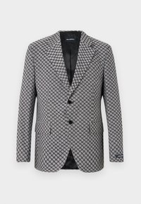 Grå houndstooth-blazer med tvåknappsstängning, snedskurna slag och två framfickor. Intern svart foder, tillverkat av texturerat tyg.