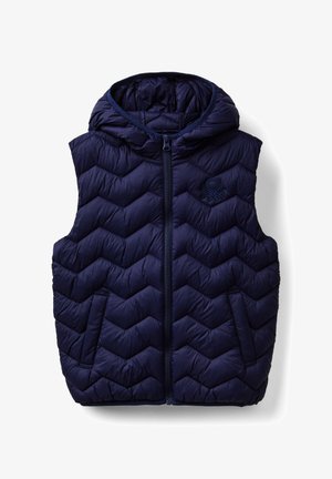 Granatowa kamizelka ocieplana z wzorem w zygzak, z zamkiem błyskawicznym i kapturem. Posiada dwie boczne kieszenie i teksturowaną tkaninę.